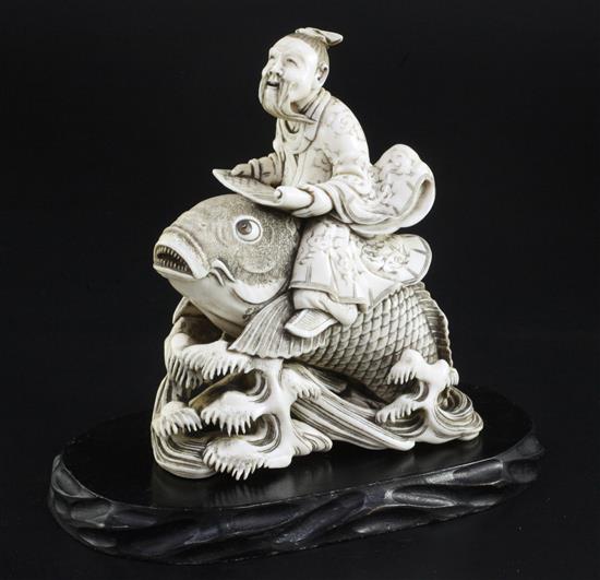 A Japanese ivory okimono of Kinko riding a carp, signed Ichyosen Naohide, 19th century, height 12.8cm, wood stand